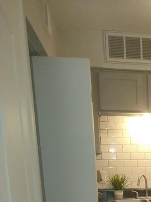 Modern, gray toned kitchen with white subway tile at Park 9690 in Dallas, TX